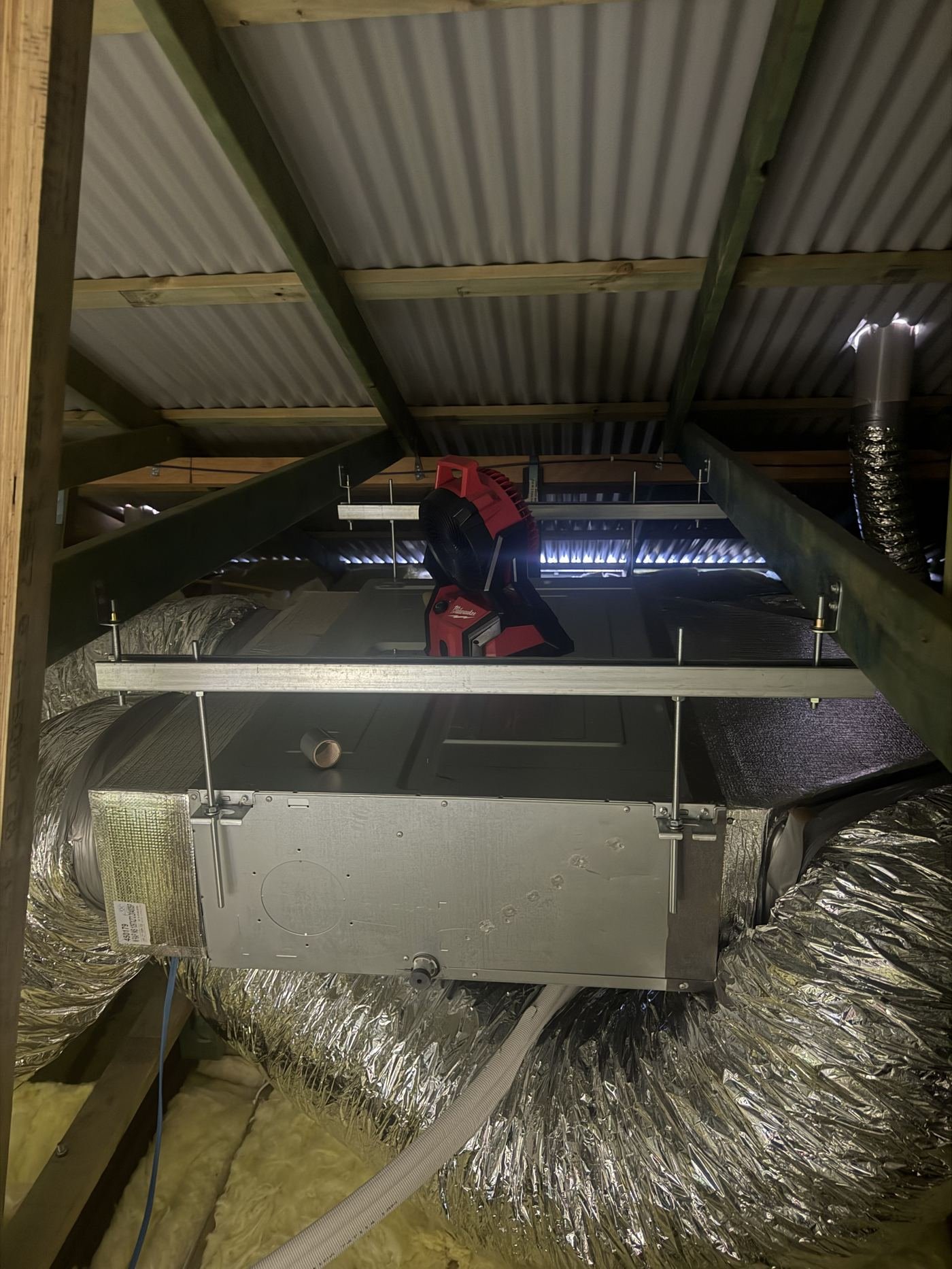 Ducted air conditioning unit installed in roof cavity